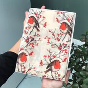 Lady holding a gift box with a christmas robin scarf design hand printed onto it