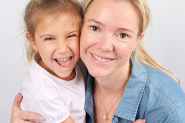 Mother and daughter hugging each other and smiling - Mia Ishaaq