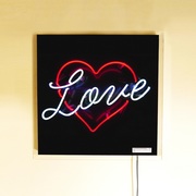 2 colour neon sign,  'love' written in red heart, real glass neon sign on a black background
