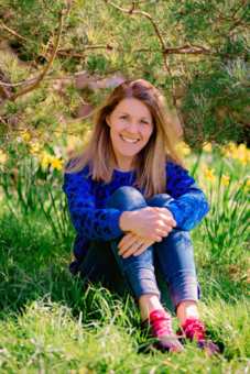 Image of Ducky Zebra founder, Sally Dear, sitting in the grass