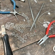 A workbench with pliers and silver on