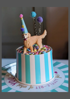Golden retriever party animal cake topper wearing party hat and pom pom balloons