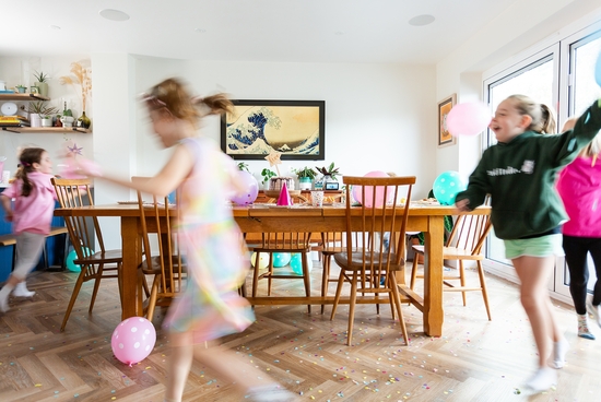 Happy Children playing around a table for Birthday Party