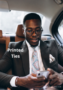 Male model wearing suit and a printed tie.