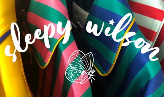 White Sleepy Wilson branding over striped pyjamas