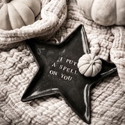 black star plate holding a mini white pumpkin