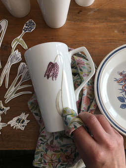 applying ceramic tranfsers of my illustrations to Latte mugs