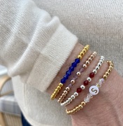 gold and silver birthstone bracelet stack