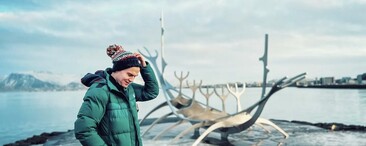 Man wearing a Fairile SuperBobble Hat with a backdrop of snowy Norway