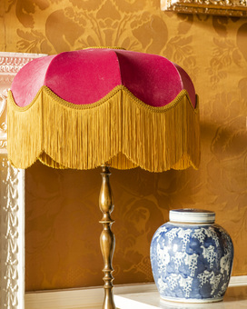 Raspberry lampshade with gold fringe
