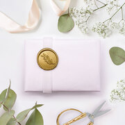 Koukla giftwrapping with luxury white ribbon and gold seal