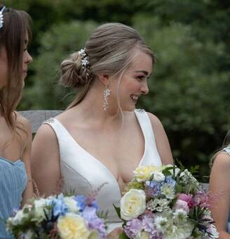 Beautiful bride wearing hand-beaded earrings