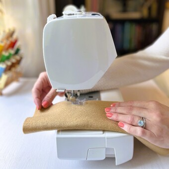Owner and creator of felt food company Kinder Cookhouse sat working at her sewing machine.