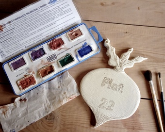 Personalised gifts being glazed ready for the second firing.
