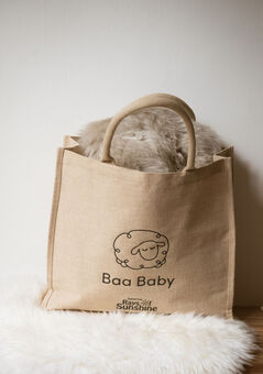 Baa Baby jute shopper bag on a pile of fluffy sheepskin pram liners