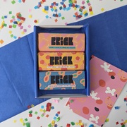 a box of three chocolate bars with confetti in the background
