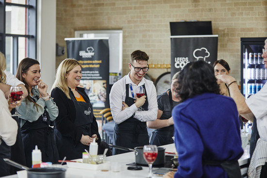 Customers enjoying a Leeds Cookery School workshop. Lots of smiles, laughs and fun.