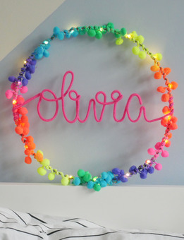 Personalised Aria hoop light with barely blush pom poms and warm grey writing