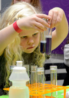 A child plays with science at a Letterbox Lab event.