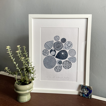 A photo of a framed hand-drawn ink illustration
