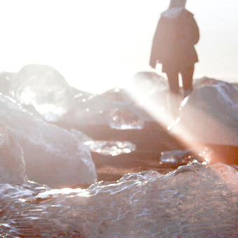 Portrait of Barnabjorn owner, Megan, walking across Diamond Beach in Iceland. 