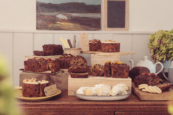 A variety of cakes, including fruit cakes in a display
