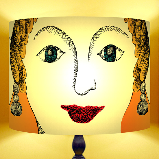 Lampshade featuring a large female face entitled ego.