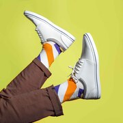 Orange and purple striped socks for men in white trainers 