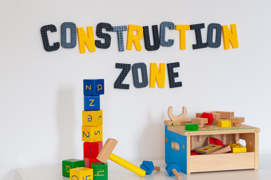 Childrens play set up with 'construction zone' in brick letters