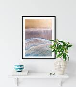 Aerial photography print displayed in a frame on a shelf with a plant