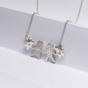 A silver necklace with 4 small silver figures connected. They have the appearance of paper dolls and each have a different texture on the surface of the silver.