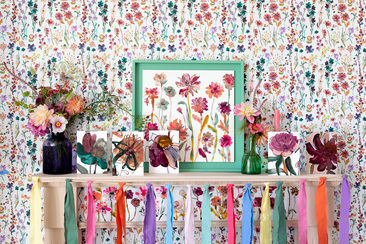 A mantelpiece with lots of floral Floradore cards. The cards are in front of a floral wallpaper and floral painting. Basically, floral-tastic maximalist stye!