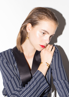 Model wearing gold modern jewelleries and blue suit