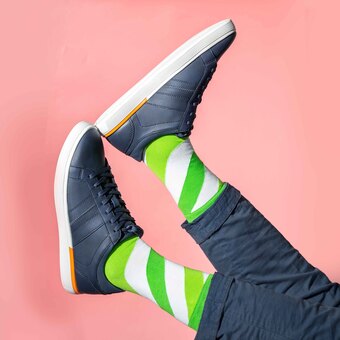 Luxury green and white striped socks for men in blue trainers