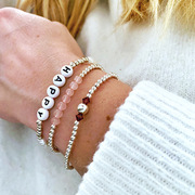 The Lovely Edit stocking bracelets being worn layered together