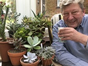 Ralph the shop owner enjoys tea in a conservatory decorated with succulent plants 