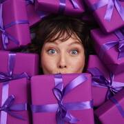 Girl under purple presents