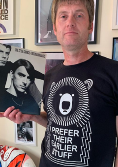 Man Holding Vinyl Record with Muso Bear T-Shirt with the Music Quote I Prefer their earlier stuff on a Black Cotton T-Shirt