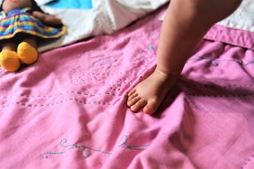 Child's foot on elephant blanket