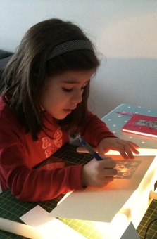 Jeta, daughter of Njomza when she was little while learning how to emboss a greeting card
