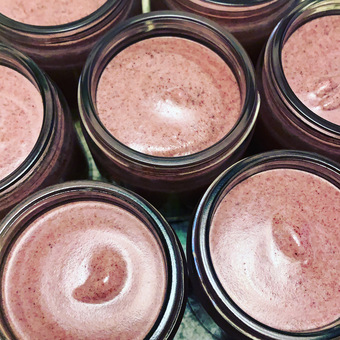 Pots of freshly made beetroot face polish in clear glass jars