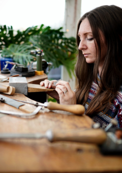 Kate wainiwrght making jewellery at her workbench