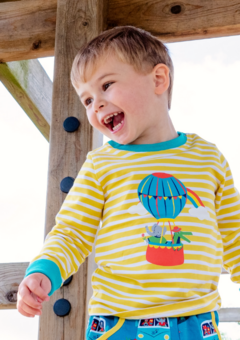 Image of a happy boy wearing a yellow and white stripe Ducky Zebra top with an elephant and crocodile in a hot air ballon