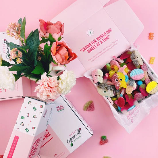 Pink themed sweet box with synthetic flowers and sweet boxes