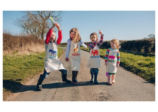 children wearing personalised aprons
