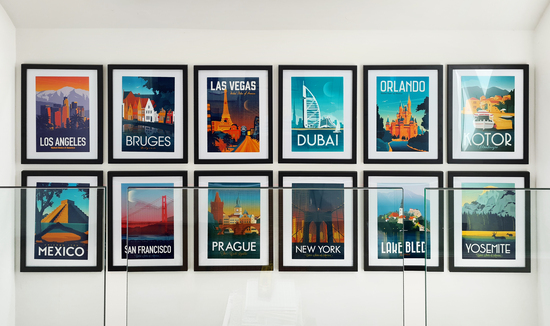 Gallery wall of colourful travel posters by Heyday Designs