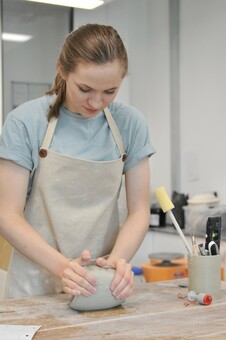 Alice wedging the clay