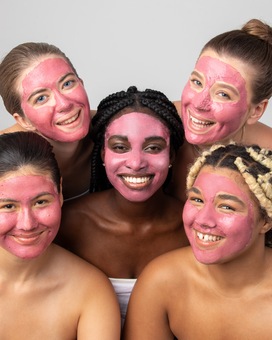 5 girls in pink clay masks