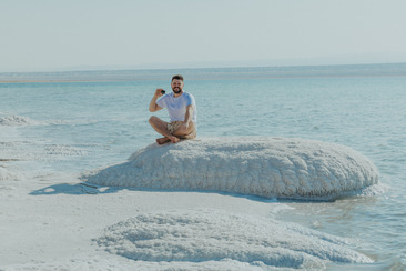 Man holding The Dead Sea Co. Mineral Mask at the Dead Sea in Jordan