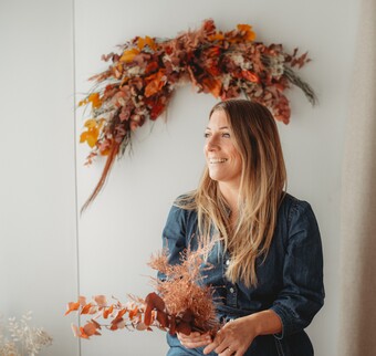 Chloe, founder of Sown and Wild surrounded by her flowers. 